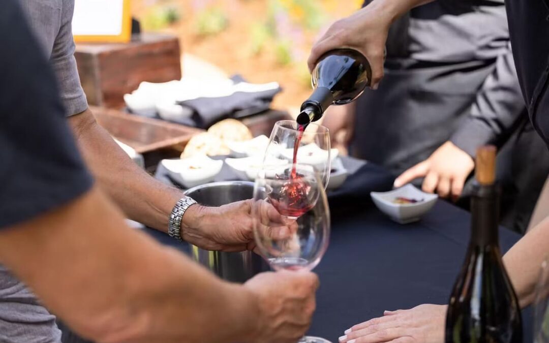 wine being poured into wine glass on table