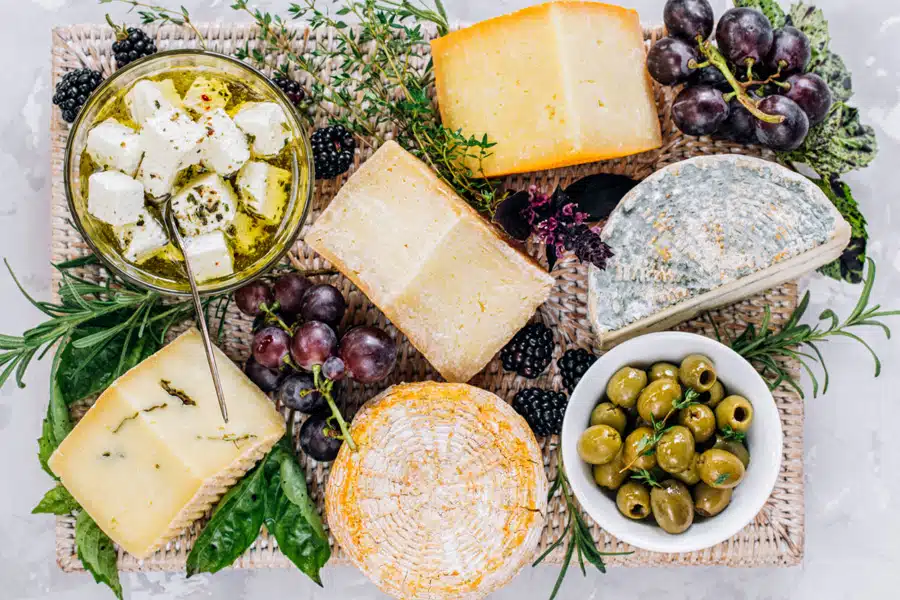 139_gourmet-food-wine-tours_1 Artisan cheese board with olives, grapes, and herbs in Yountville – one of the best things to do in Napa Valley for food lovers.