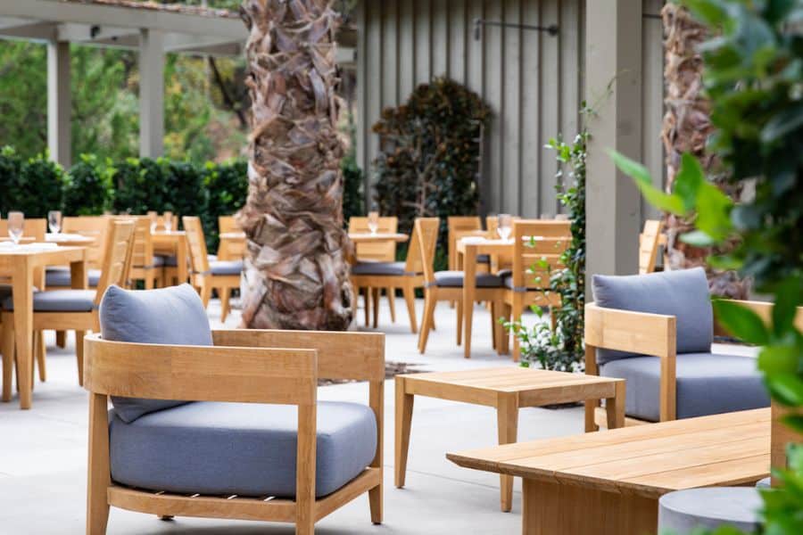 outside dining with wood chairs at Meadowood