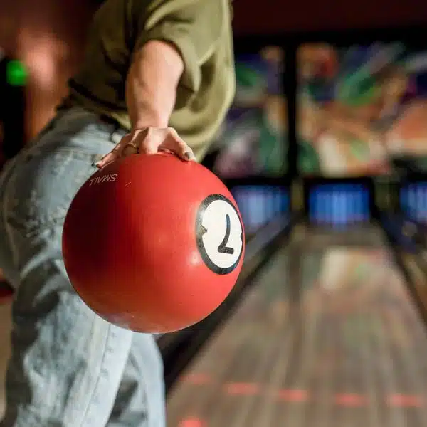 person holding a bowling ball with a number 7