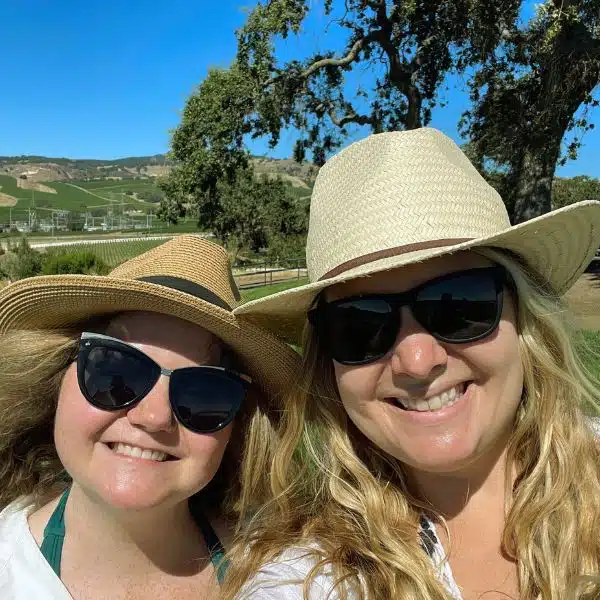 Jessica and Laticia in hats and sunglasses smiling