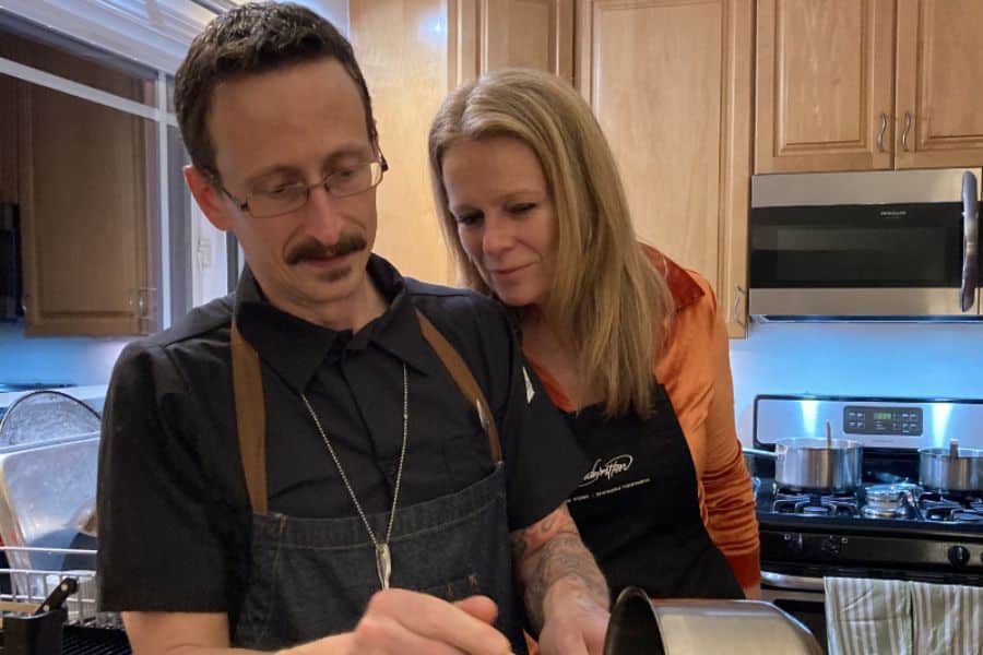Photo of a man and women cooking