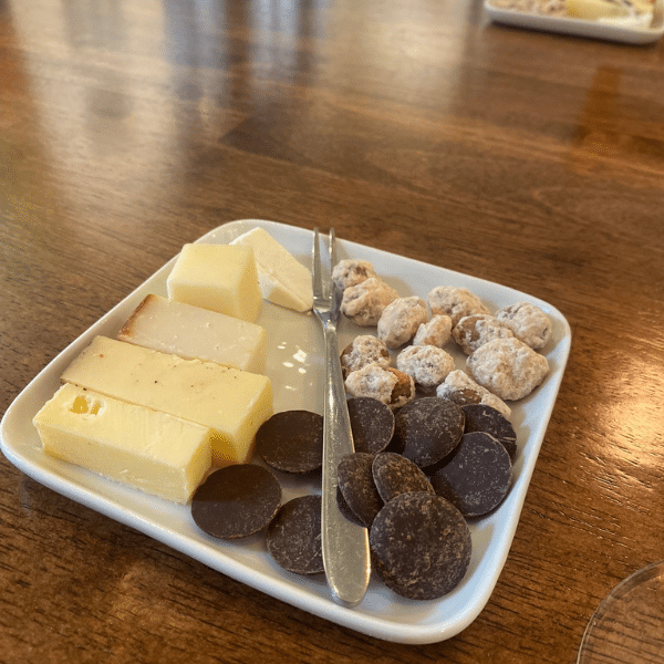 A plate with chocolate, cheese and nuts