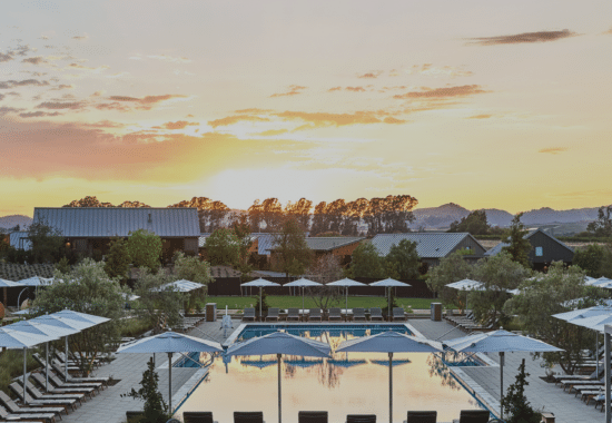 A view of Stanly Ranch Resort, loverlooking the pool with vineyards in the background