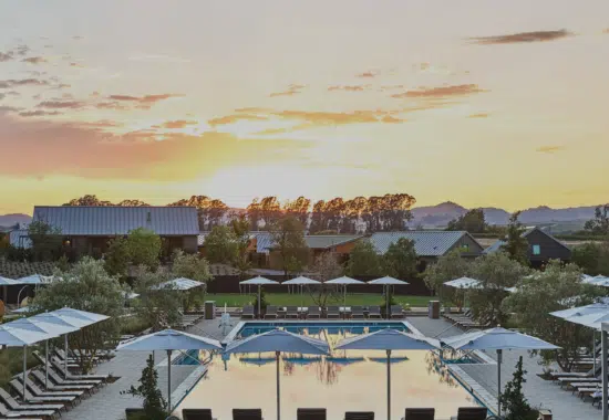 A view of Stanly Ranch Resort, loverlooking the pool with vineyards in the background