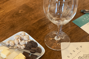 plate with chocolate, cheese and nuts, wine glass and Jessup Cellars Menu