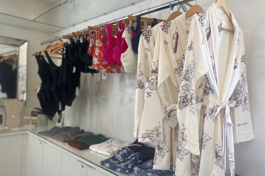 Robes, swimsuits line a boutique rack
