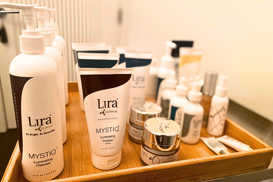a wooden tray filled with Lira Clinical Skin Care products