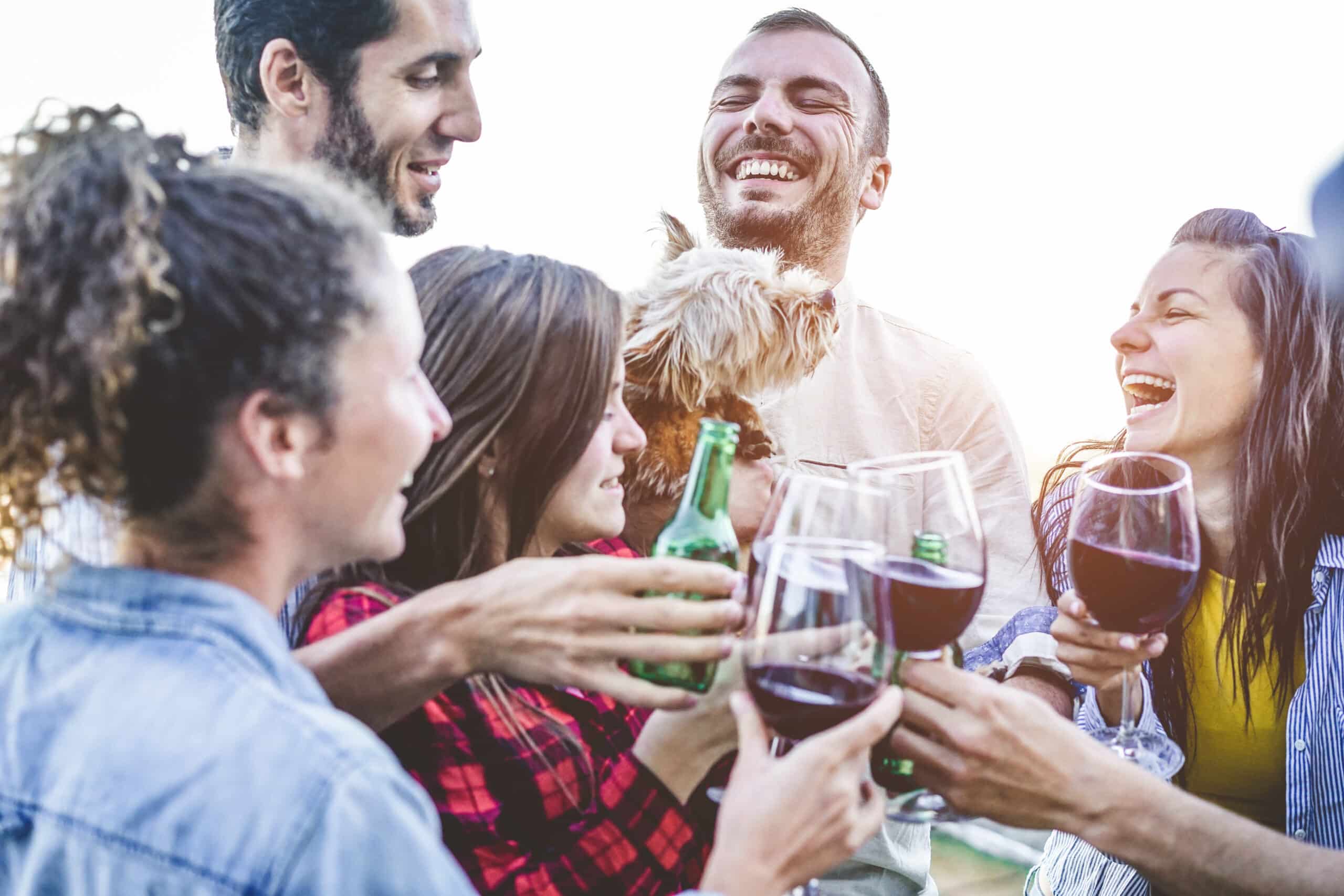 Happy friends taking selfie during party dinner at home backyard