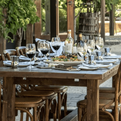 07 23 Winemaker Lunch Sumerston (1) wood table with place settings outside<br />