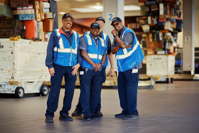 08 23 airport5 group of employees standing around airport