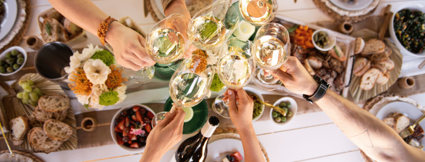 people clinking glasses over table