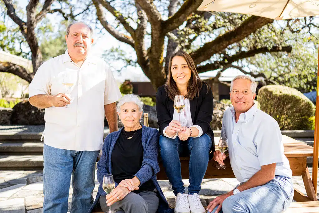 people sitting with chandon wine in hand smiling