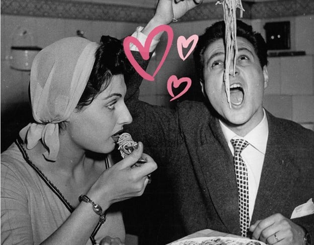 black and white photo of a couple eating together