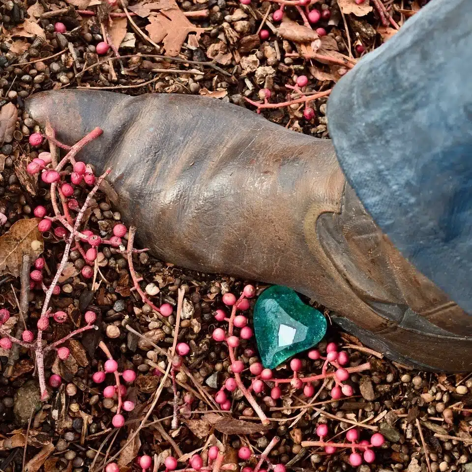 boot with a heart next to it on ground