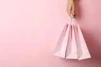 pink gift bags held against a pink wall<br />
