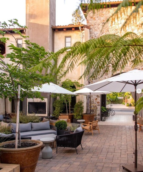 outside patio with umbrellas between buildings