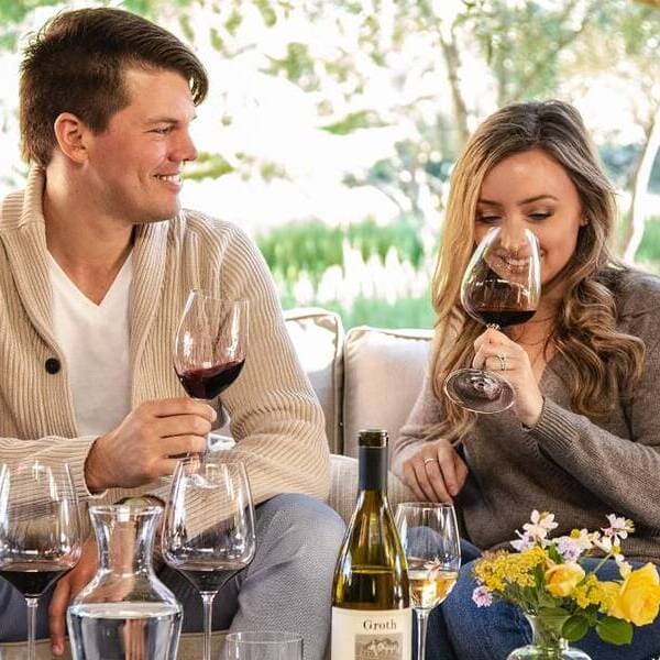 Couple tasting wine outside<br />
