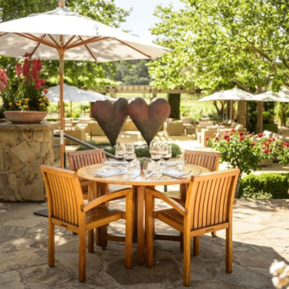 Cliff Lede Wooden tables and chairs on patio