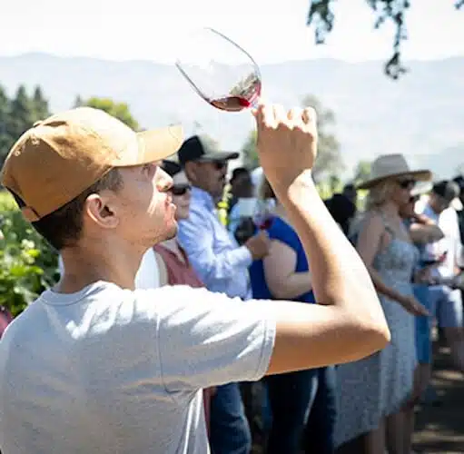 man holding up wine glass