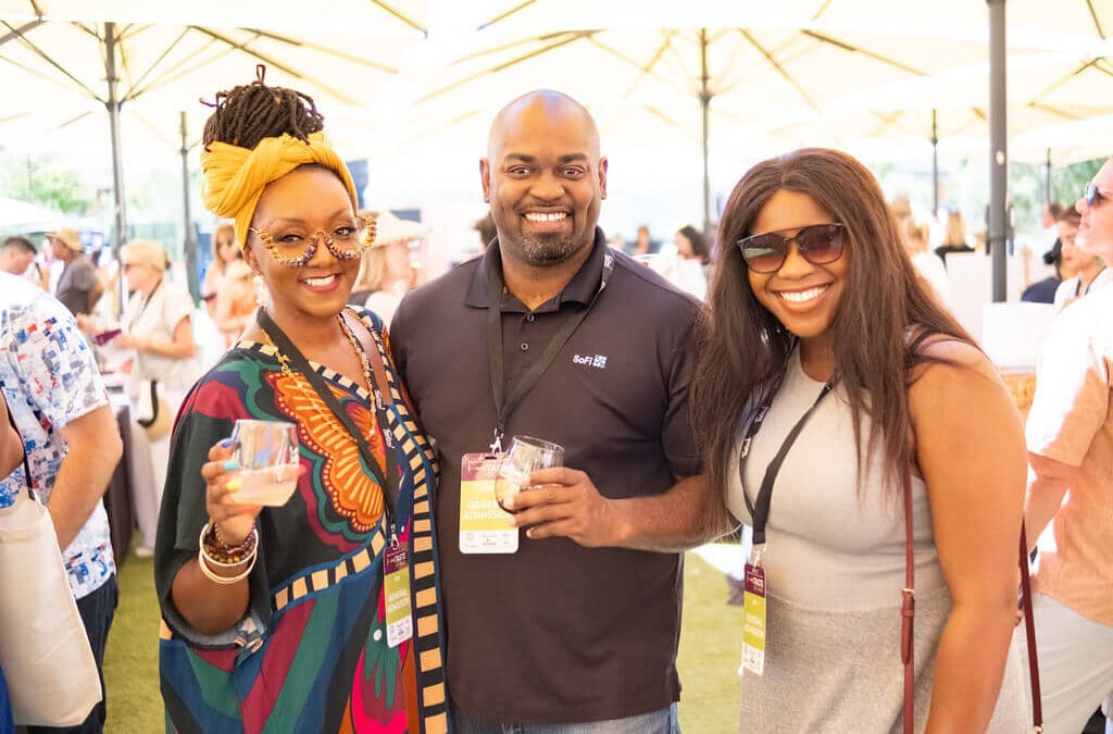 people smiling at wine tasting event