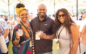 people smiling at wine tasting event