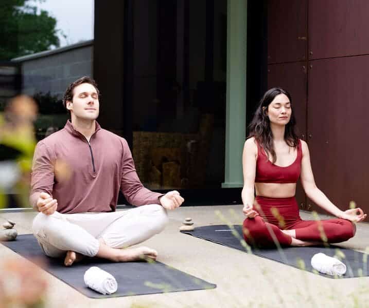 woman and man meditating outdoors