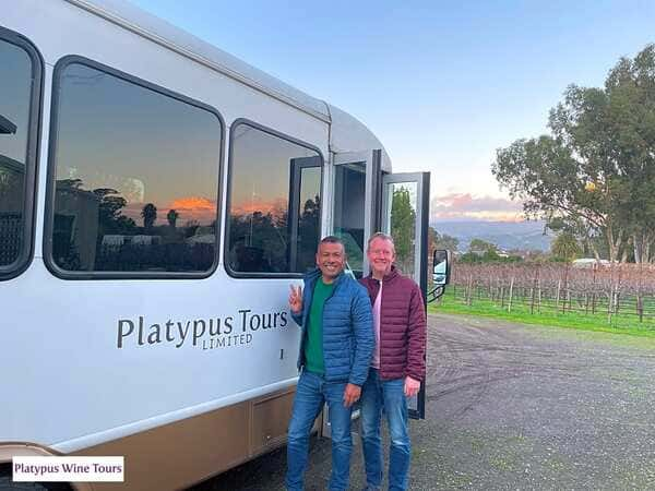 people standing next to tour bus