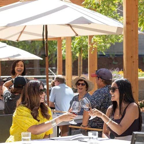 people sitting around table drinking wine<br />
