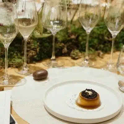 wine being poured into wine glass on table