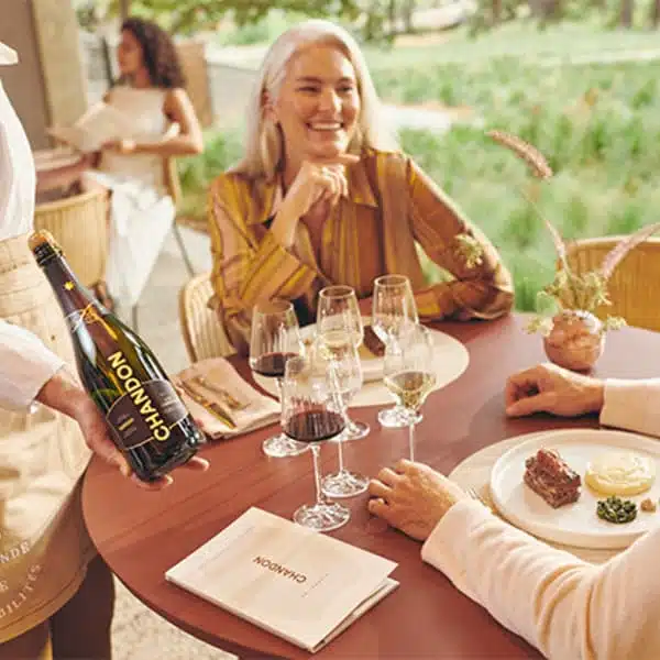 woman sitting at table wine tasting