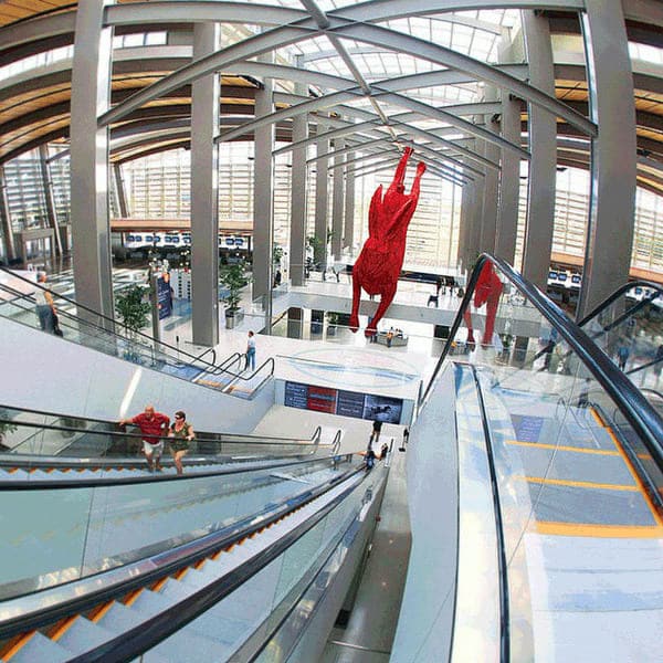 red rabbit sculpture above escalators 