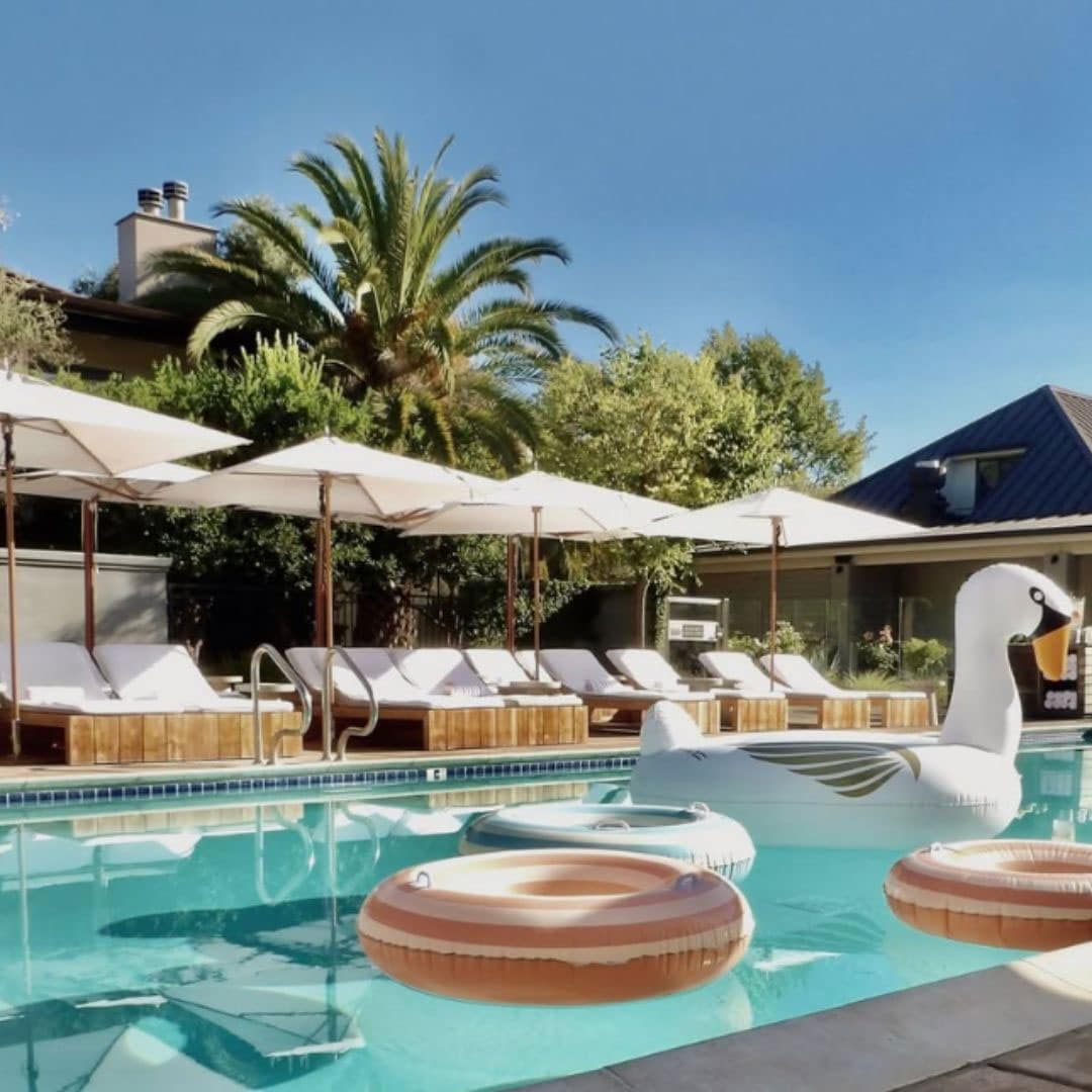 swimming pool with lounge chairs and umbrellas